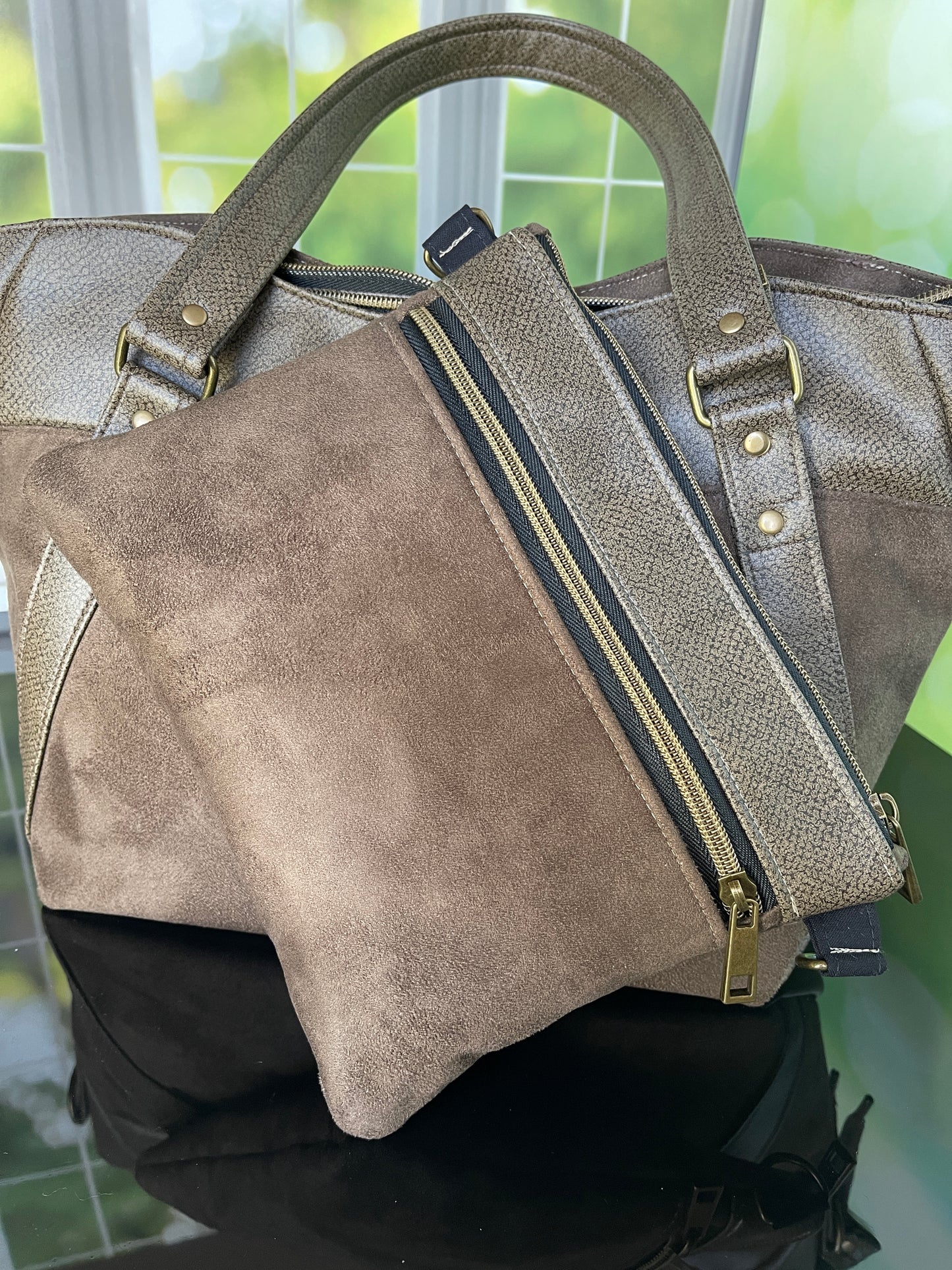 Brown faux leather and faux suede Handbag with matching zipper pouch.